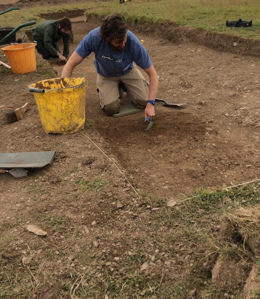 Volunteer Sam excavating in trench 9