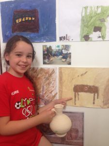 Here is Katie and her painting. Her class tasted the Roman style bread, she said it was "tasty".